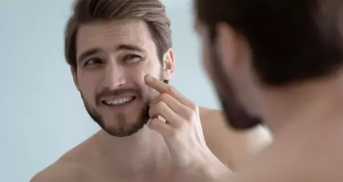 A gay man checks his face for potential monkeypox rash