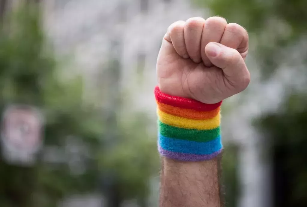 A man raises a fist while marching along the parade route during the San Francisco Pride parade in San Francisco, California.