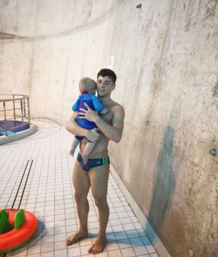 Tom Daley and Dustin Lance Black take son for first swim