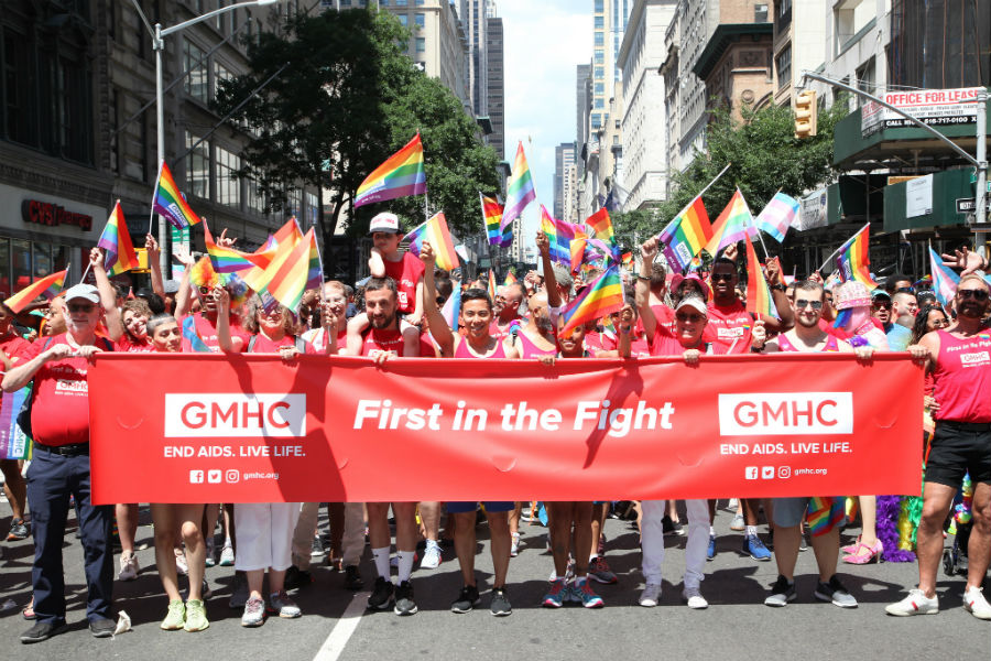 Kelsey Louie (center) marches with GMHC at New York Pride 