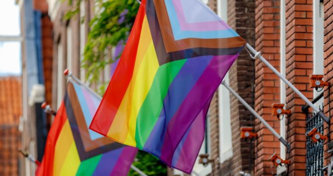 A Progress Flag for LGBTQ rights outside a building