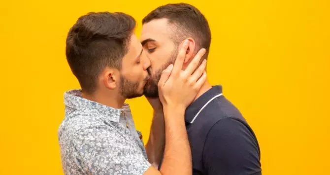 Two men kiss