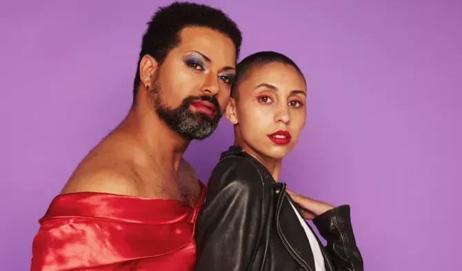 Drag queen with androgynous female. Two model breaking gender stereotypes on purple background.