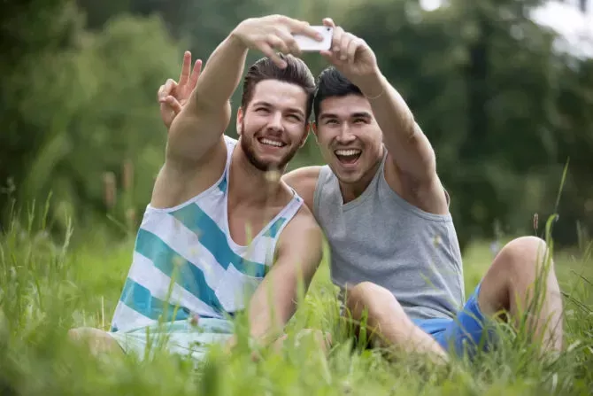 Two Male Friends Posing For Selfie In Summer Field Together