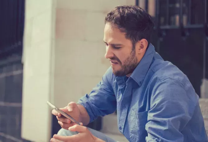 Frustrated man using phone