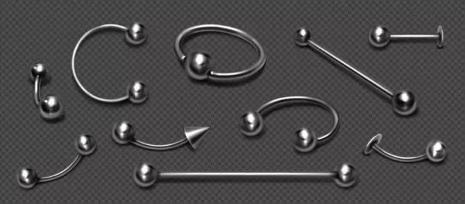Set of piercing jewelry, metal pierce rings, barbell with balls and cones for face and body decoration