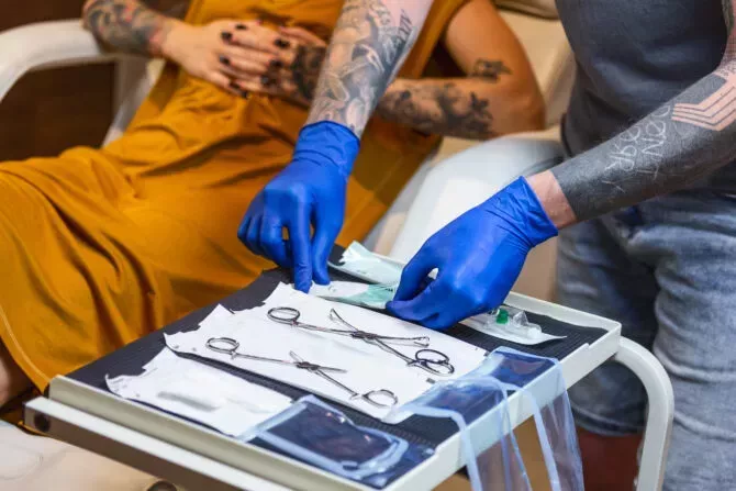 Close up of man opening sterile dual process indicators equipment for piercing