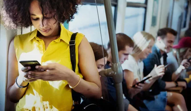 Woman looks at her phone while riding the bus