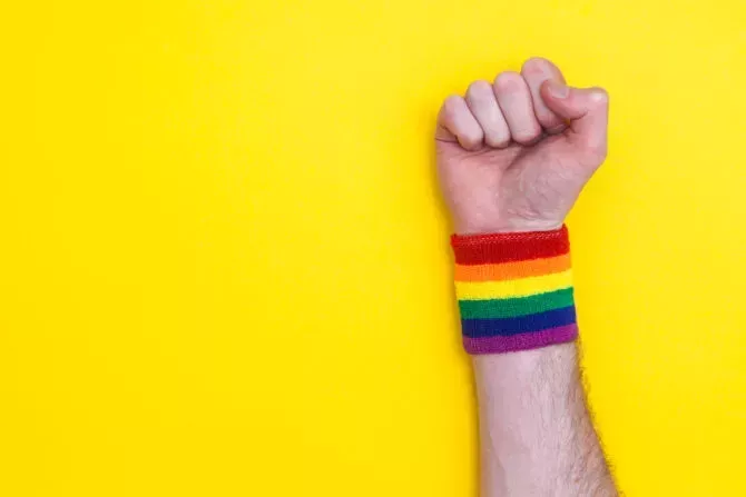 closeup of fist wearing rainbow wristband