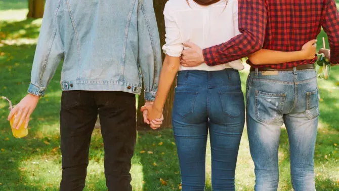 Woman standing with two guys in nature park