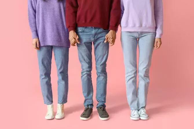 Man and two beautiful women on color background