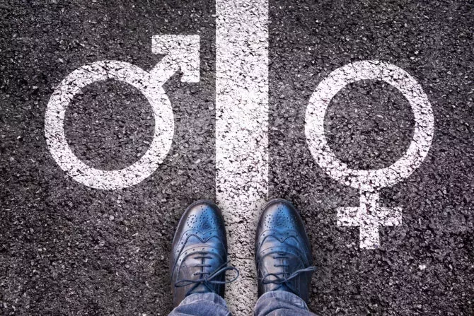  Legs with gender symbol on asphalt