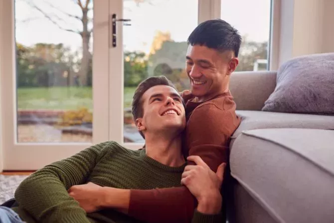 Gay couple relaxing indoors