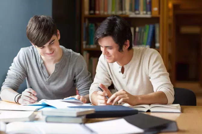 Students preparing an essay in the library