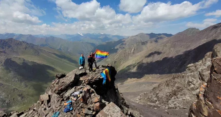The mountaineers hoist the rainbow flag on Vladimir Putin Peak