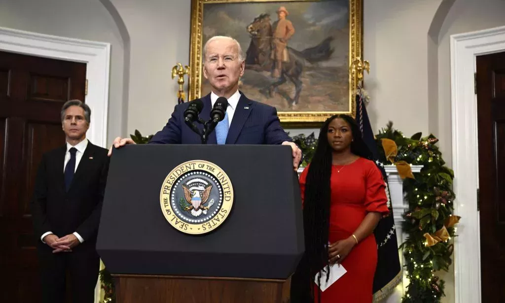 President Joe Biden speaks at a podium at the White House to share the news that Brittney Griner was released from a Russian penal colony