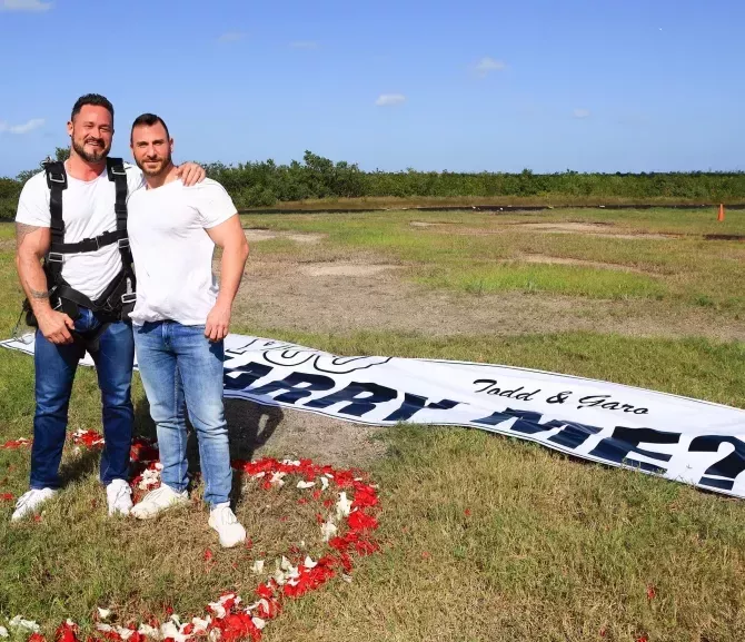 Todd and Garo and the 'Marry Me' banner 