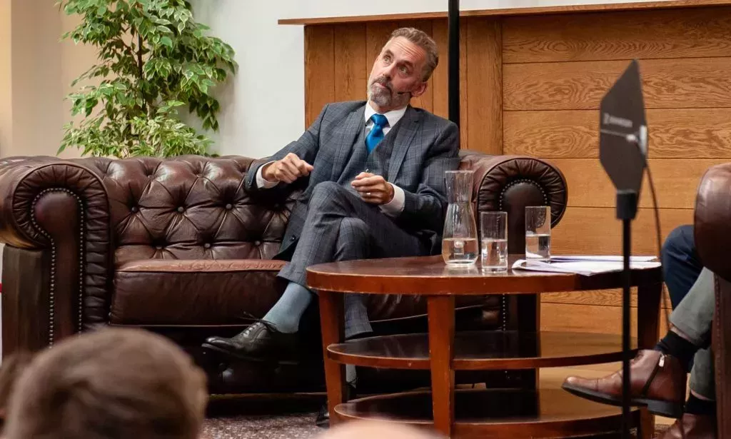 Jordan Peterson looks up at the ceiling during a live discussion.