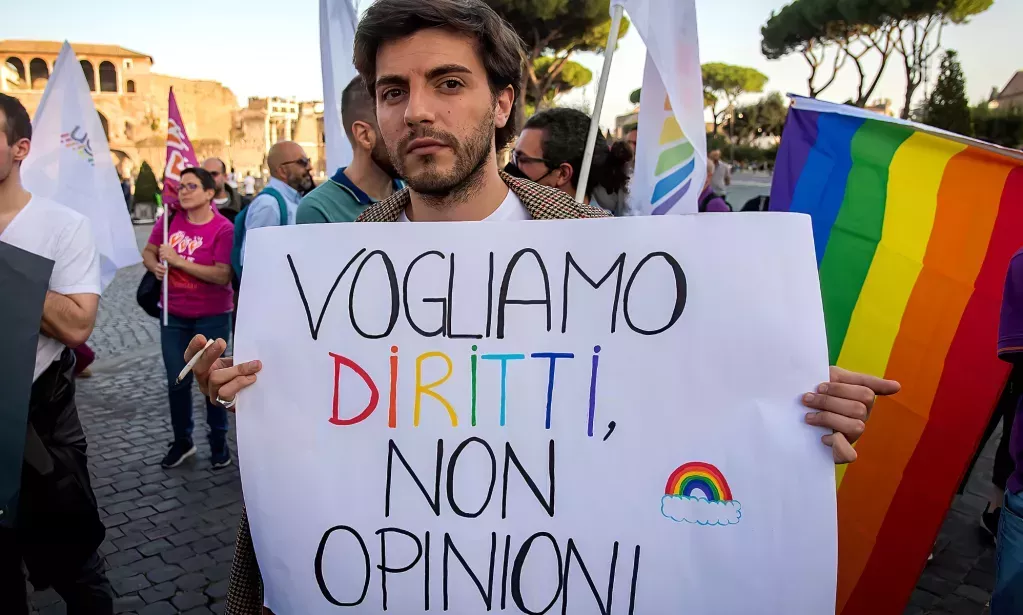 A protester holds a sign that reads: "We want rights not opinions" during a rally in support of the Zan bill, which would have criminalised anti-LGBTQ+ violence and discrimination in Italy