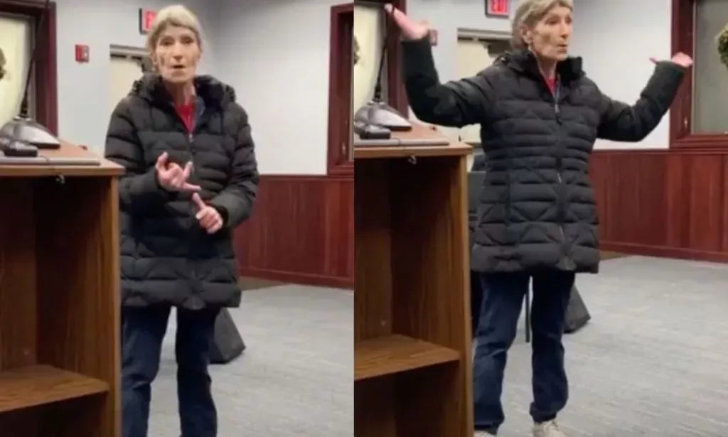 A librarian gestures with her hands as speaks before a board meeting about threats and harassment she's received because conservatives are angry over the library's LGBTQ+ books collections