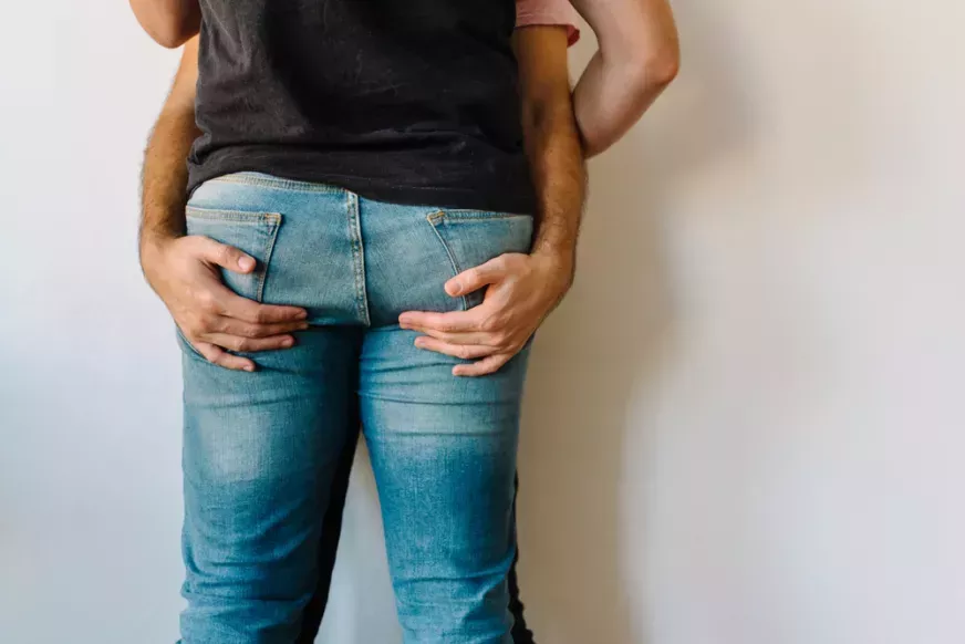 Gay couple in jeans hugging