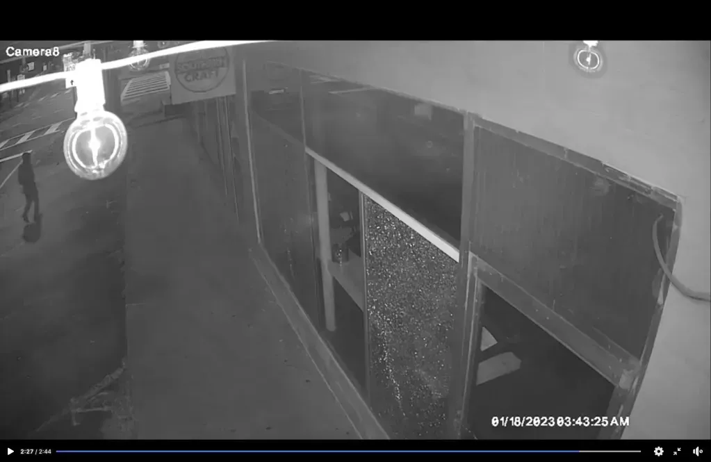 CCTV footage of a person shooting out a window 
