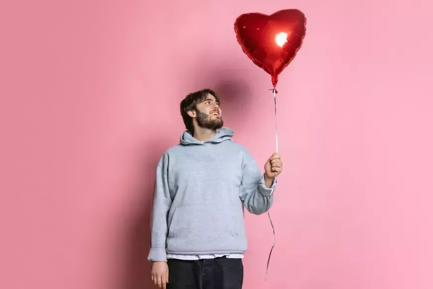 Man holding heart balloon