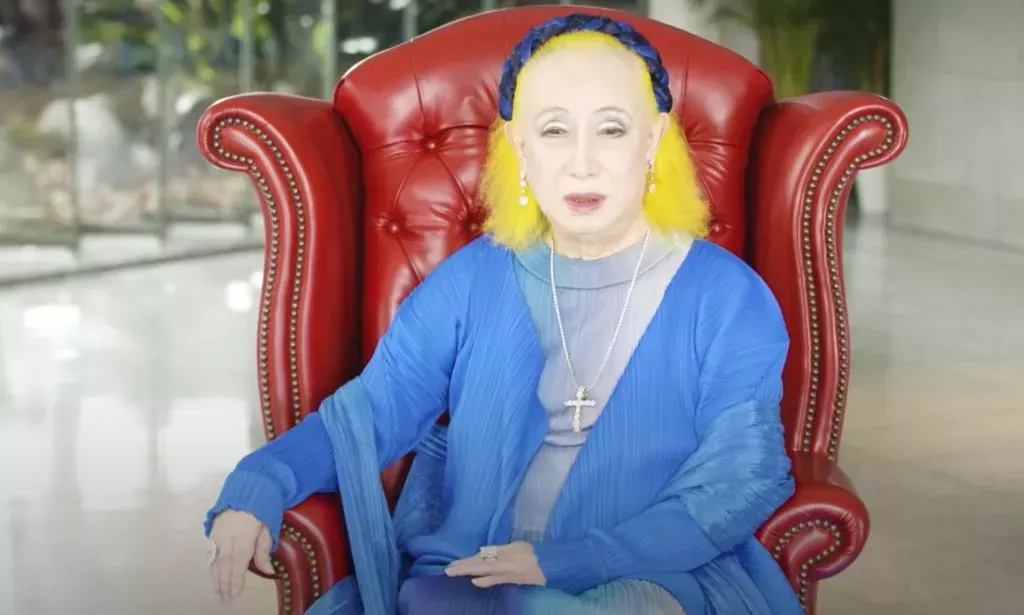 Akihiro Miwa, a Japanese drag queen and queer icon, wears a blue outfit as he discusses different aspects of his life