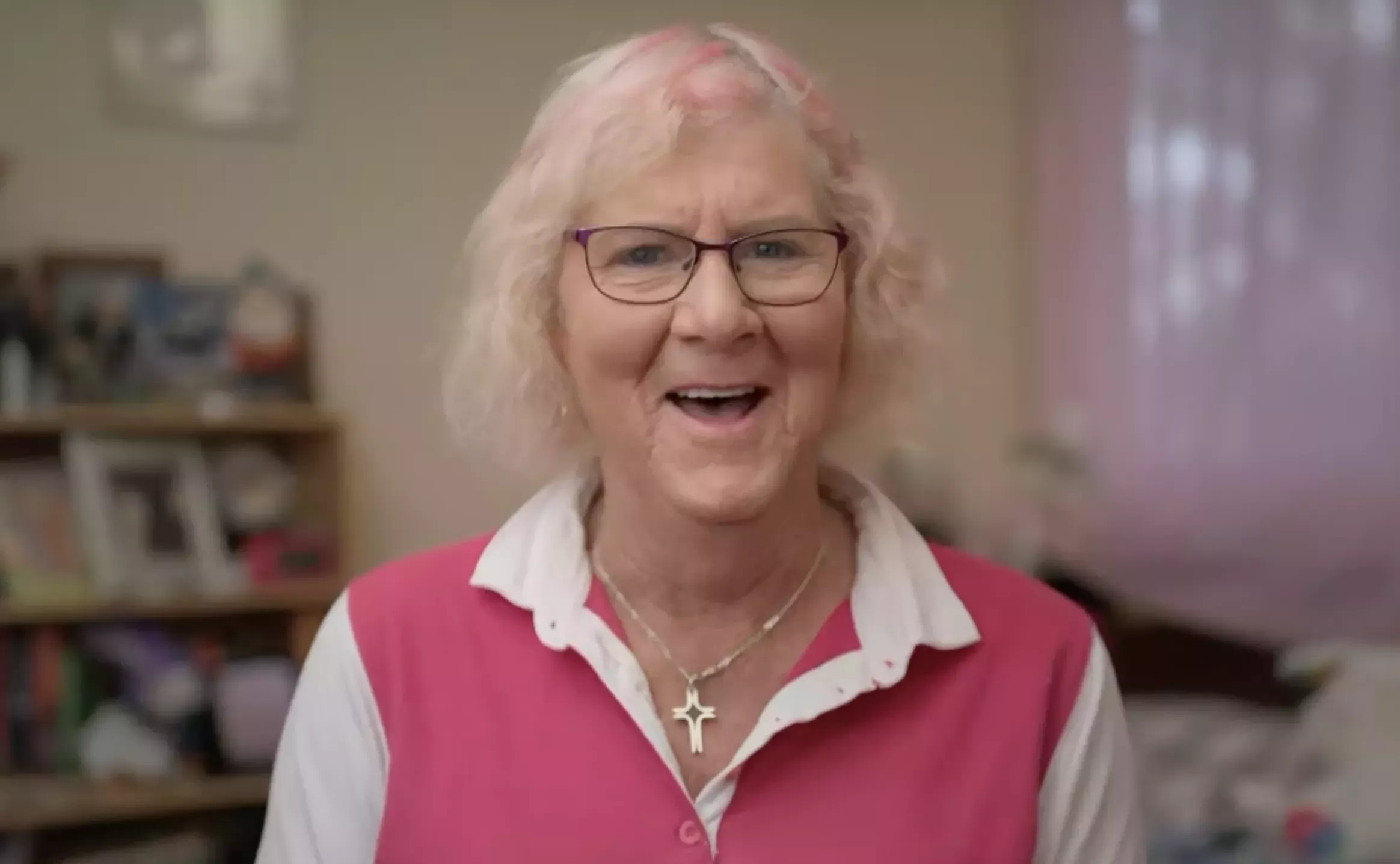 Dianne Harris sits in a white collared shirt and a pink vest.