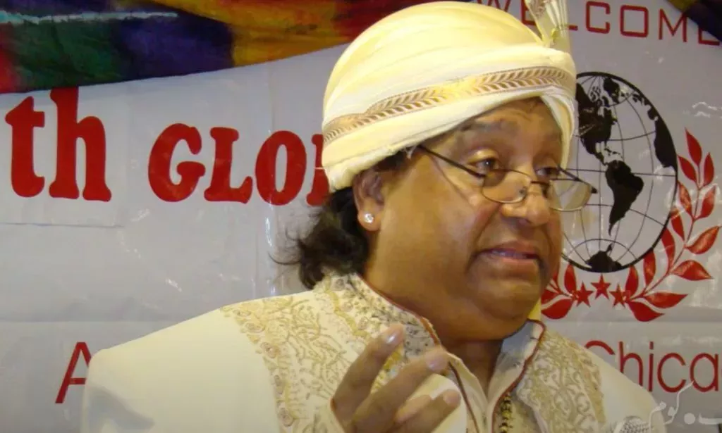 Gay Pakistani poet Ifti Nasim wears a white outfit as he speaks at an event