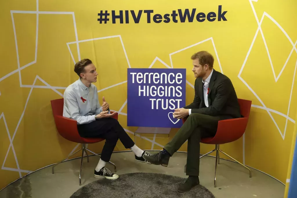 Prince Harry speaks to Andrew Bates, aged 23, who was diagnosed with HIV in 2015, during his visit to the opening of the Terrence Higgins Trust (THT) HIV testing pop-up shop in Hackney, east London, to launch National HIV Testing Week on November 15, 2017.
