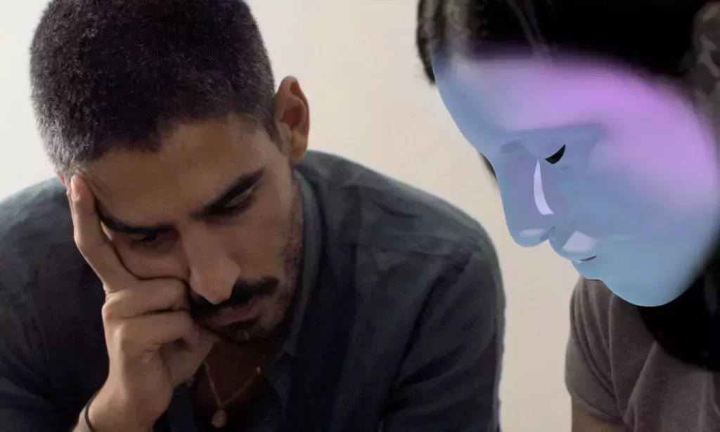 Laila, a trans person whose identity has been protected by masking technology, looks at a phone and details a story of being persecuted for being part of the LGBTQ+ community in Egypt with a journalist as part of a BBC documentary