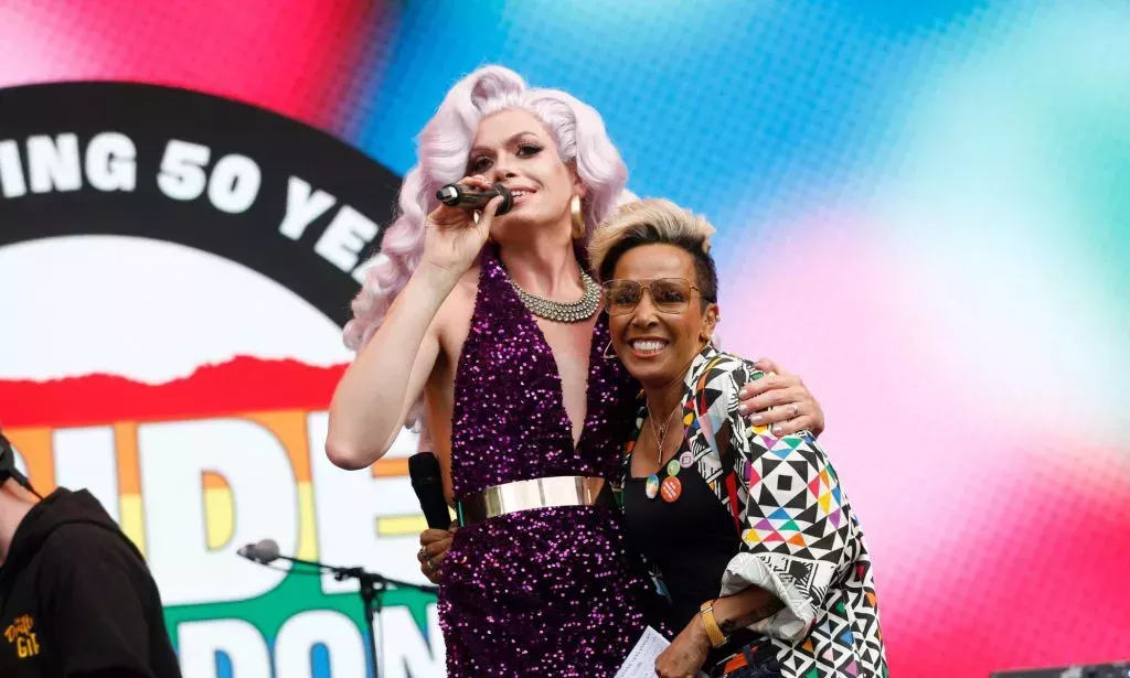 Dame Kelly Holmes on stage at Pride in London hugging a drag queen.