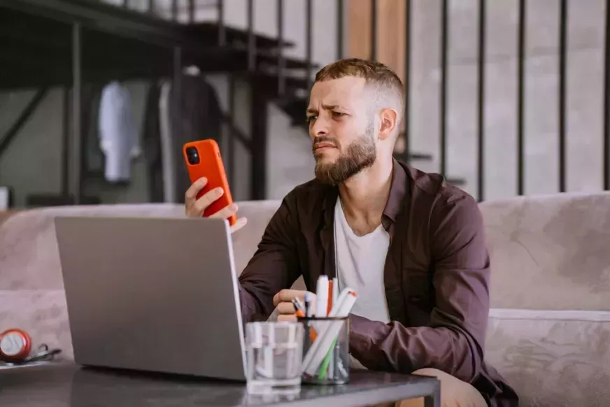 Confused man looking at phone