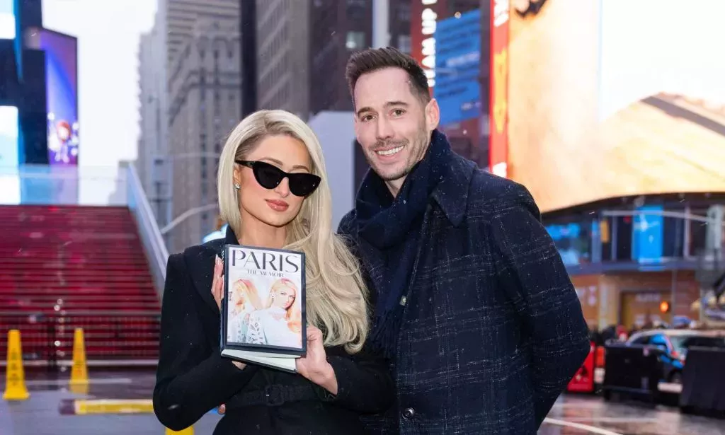 Paris Hilton and Husband Carter Reum promote Paris: The Memoir in New York's Times Square.
