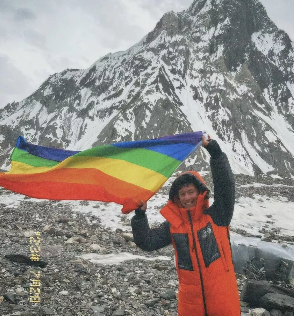 Aidan Hyman waving a rainbow flag.