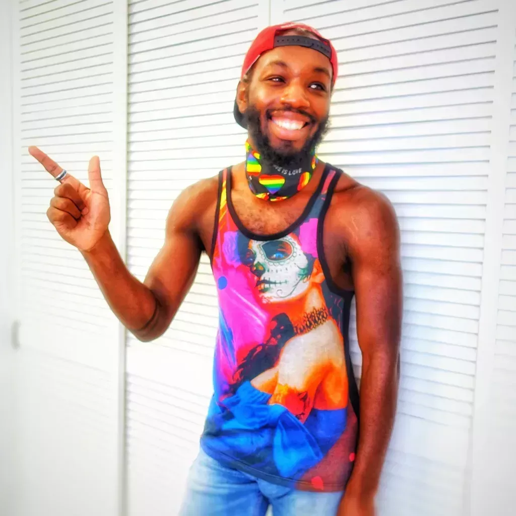 Aaron Miller in a multicoloured vest and cap