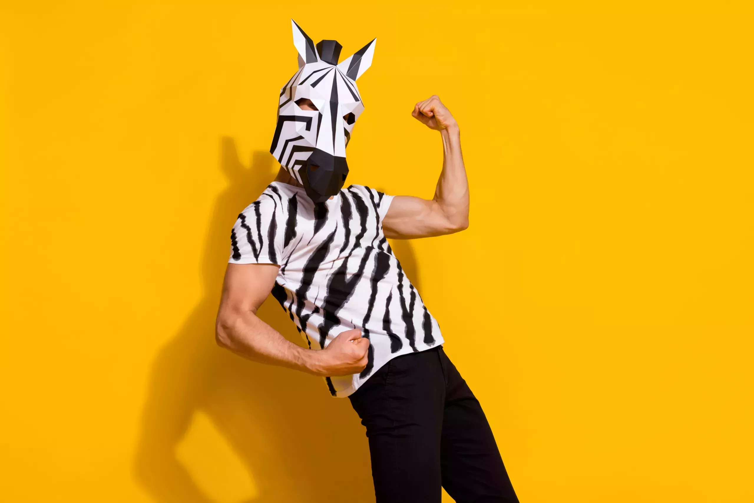 A man wearing a zebra hat and t-shirt.