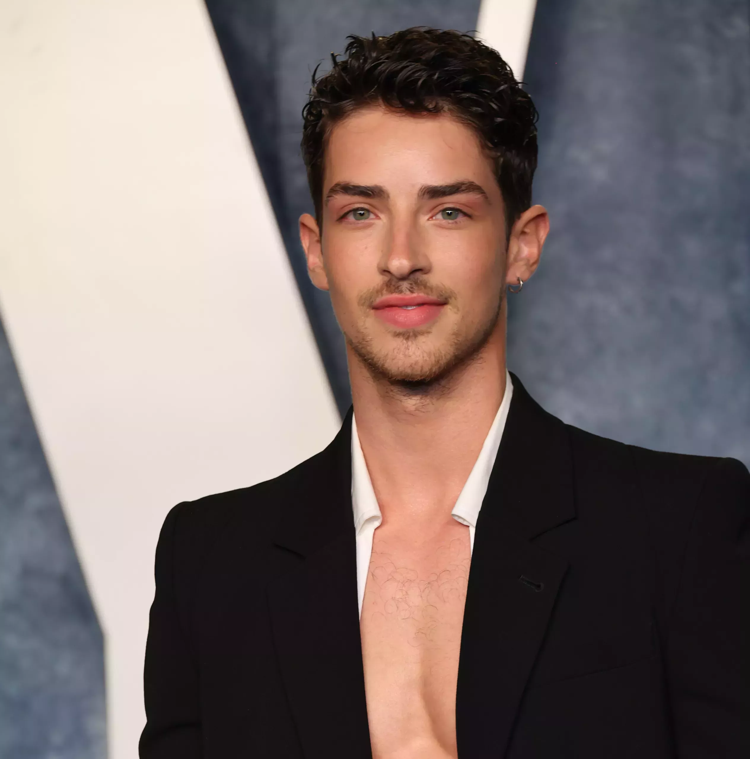 Manu Rios in a black blazer