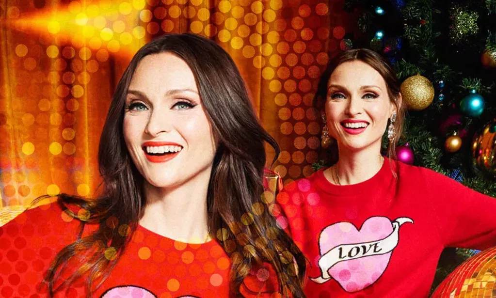 Singer Sophie Ellis-Bextor wearing a Christmas jumper with a heart on it that reads the word 'love'.