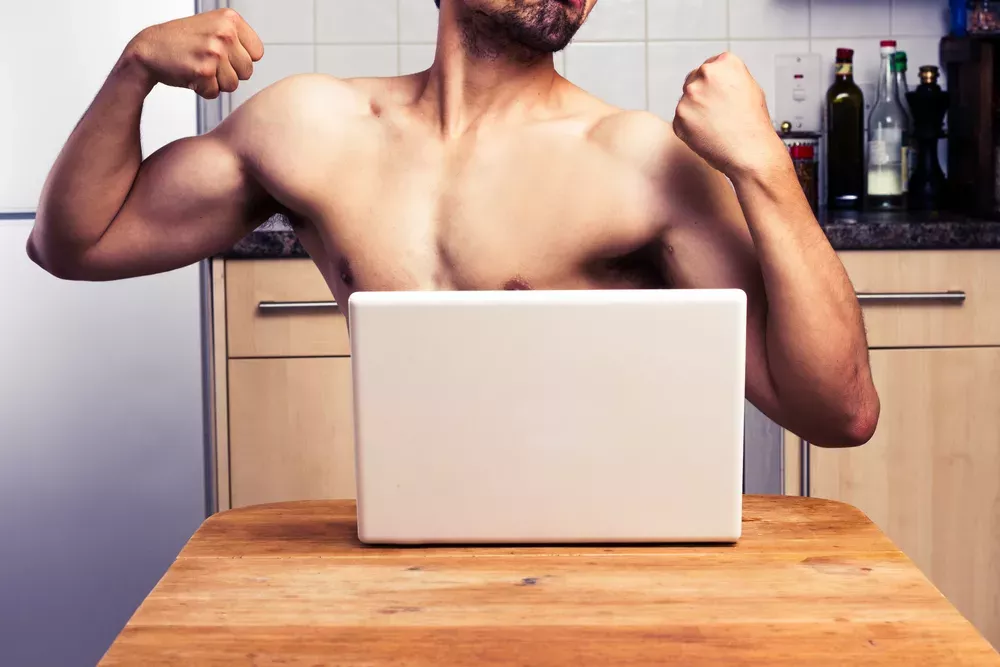 Naked man using computer