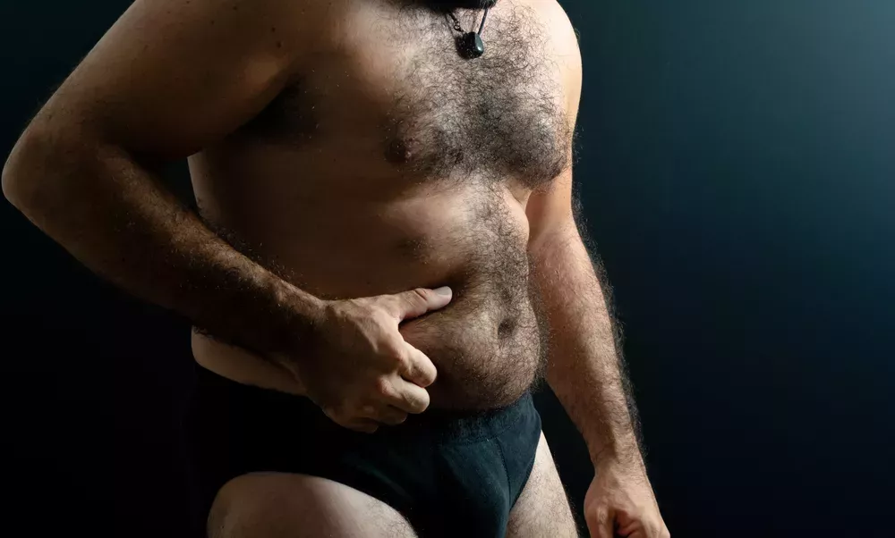 Stocky guy holding belly