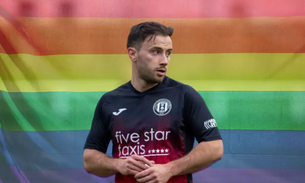 Footballer Zander Murray in front of a Pride rainbow