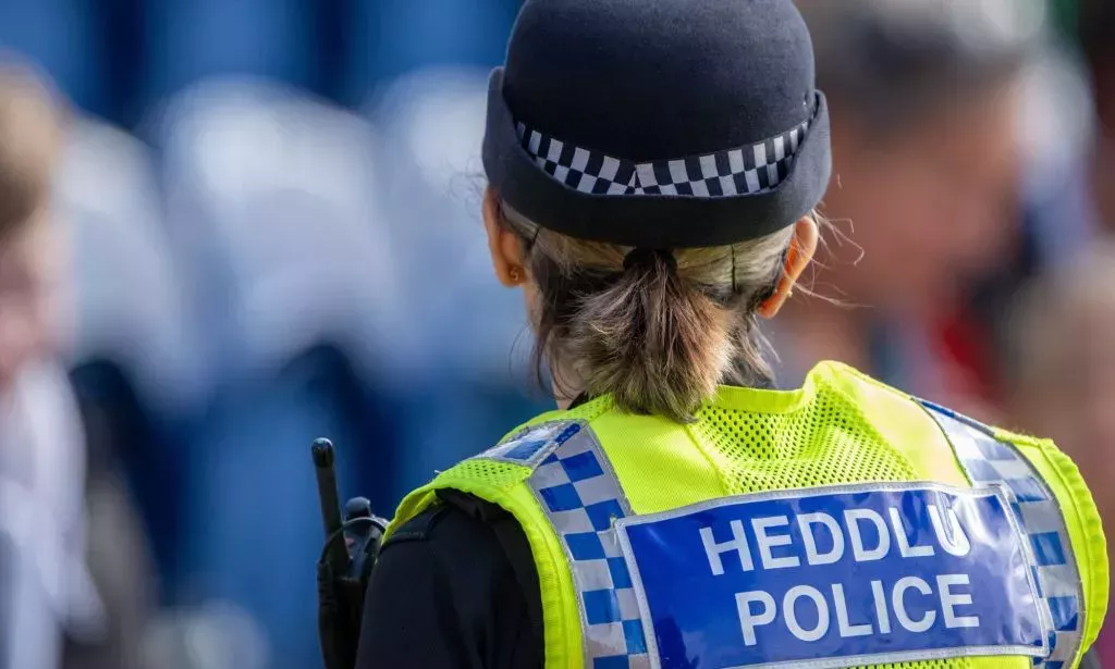 The back of a Wales Police officer.